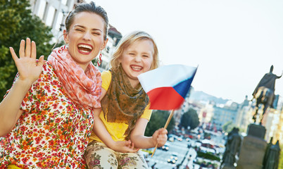 mother and child travellers with Czech flag handwaving