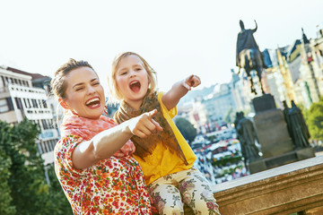 mother and child travellers in Prague pointing on something