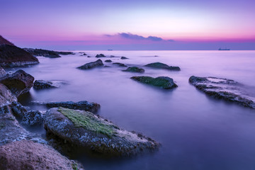 tranquility and calm long exposure rocky coast before sunrise .