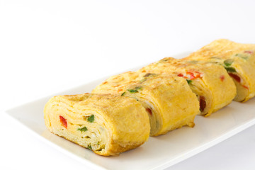 Traditional tamagoyaki Japanese omelette isolated on white background