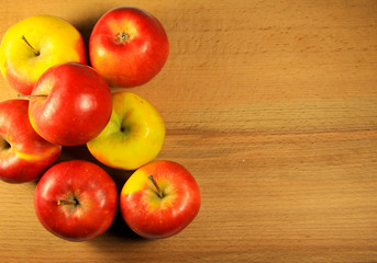 Fresh red apples on wooden background