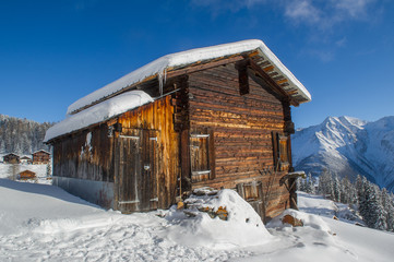 old wooden barn in a winter landscape