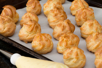 French dessert croquembouche. Wedding cake. New year dessert. Homemade eclairs filled with custard. Profiterole. 