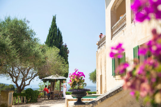 Guests and waitress serving outside boutique hotel, Majorca, Spain