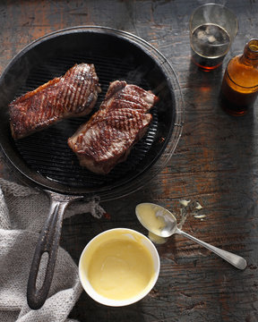 Sirloin steak in frying pan with bearnaise sauce