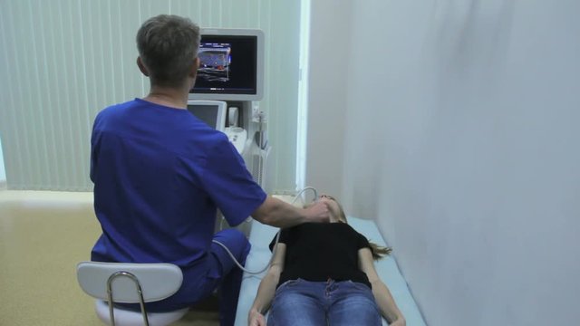 Doctor makes Ultrasonography thyroid girl