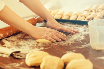 Obraz na płótnie Canvas Woman Working With Dough, Making Croissants. Close up.