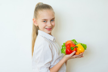 Happy fitness girl holding vegetables isolated