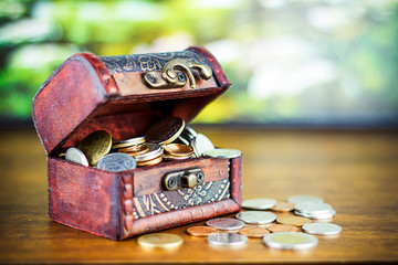 Saving money concept preset putting money coin stack growing business on bright light glowing bokeh background, business finance wealth and success concept.