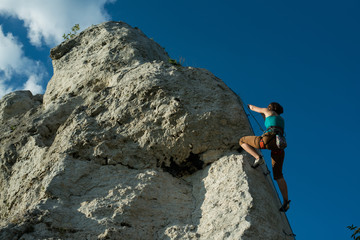 Woman is climbing on a vertical wall, Poland