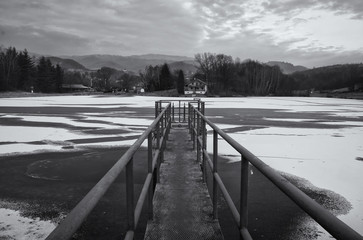 Black and White Pier on Frozen Lake in Winter