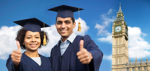 happy students or bachelors showing thumbs up