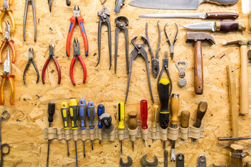 work tools hanging on wall at workshop