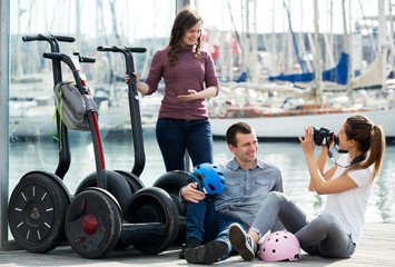 Fototapeta premium Company of friends sitting near segways