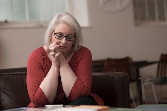 Woman looking upset on couch