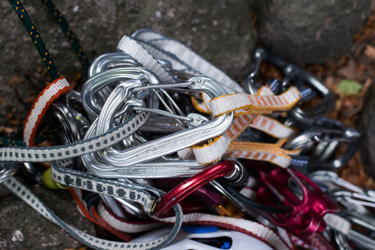 Safety harness with quick-draws and climbing equipment outdoor on a rock.