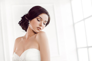 Naklejka na ściany i meble Beautiful bride. Wedding hairstyle make-up luxury fashion dress concept