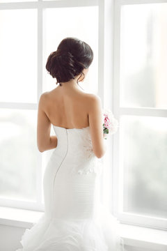 Beautiful bride in front of a window