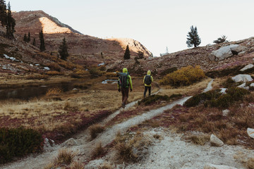 Rear view of two male hikers hiking up rugged landscape, Mineral King, Sequoia National Park, California, USA