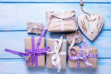 Many  festive gift boxes with presents and decorative heart on b