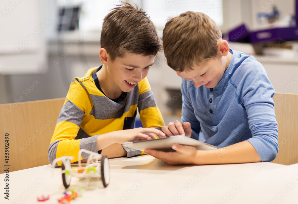 Wall mural kids with tablet pc programming at robotics school