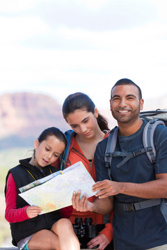 Girl and adult hikers looking at map, Sedona, Arizona, USA