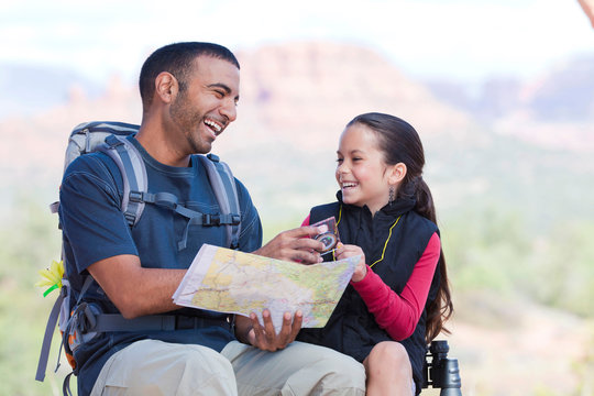 Hiking girl and young man looking at map, Sedona, Arizona, USA