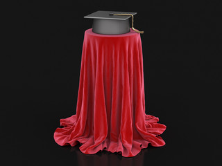 Graduation cap on table covered cloth. Image with clipping path