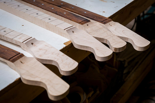 Headstocks and necks of guitars in workshop
