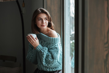 Young pretty cute woman look at window in cafe