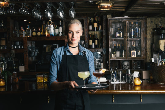 Waitress holding tray of cocktails