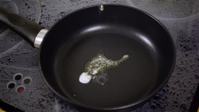 Fried egg. Raw egg on the frying pan in slow motion.