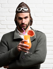 Fototapeta premium bearded pilot with cocktail in glass