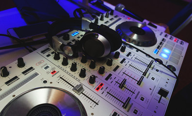 Fototapeta na wymiar DJ mixer in bright colors disco in a nightclub. 