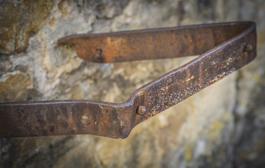 Architectural steel object hanging out of a wall closeup