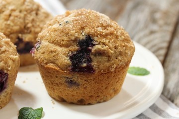 Homemade Whole wheat Blueberry Muffins on wooden background, shallow depth of field