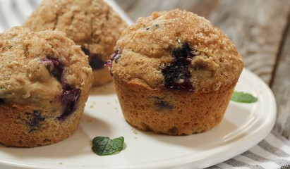 Homemade Whole wheat Blueberry Muffins on wooden background, shallow depth of field