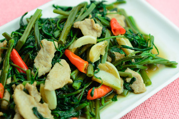 close up of stir fried water convolvulus with pork loin, thai style homemade food