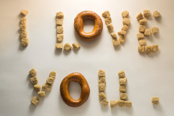 The words '' I Love you '' are made of dark sugar and bagel