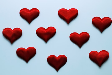 Soft plush red hearts on a white background