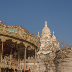 Obraz premium Paris, basilica Sacre-Coeur with a merry go round