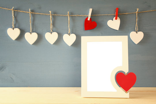 Blank photo frame with red heart