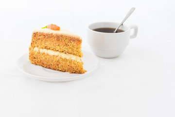 Carrot Cake on white dish with hot drink