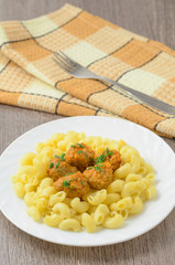 Pasta with meatballs on the plate.