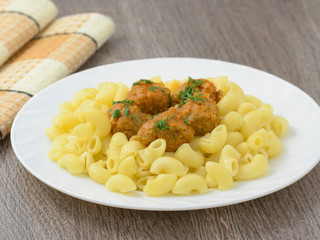 Pasta with meatballs on the plate.
