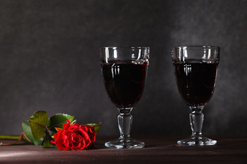 Two wine glass on dark table