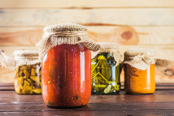 Preserved vegetables on wooden background