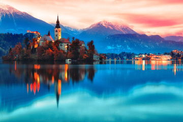 Night scene of Bled lake in Slovenia, famous and popular travel destination for romantic couple in love. Artistic toning landscape. - obrazy, fototapety, plakaty