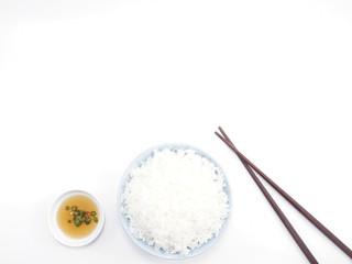 Rice in a bowl with chopsticks isolated top view