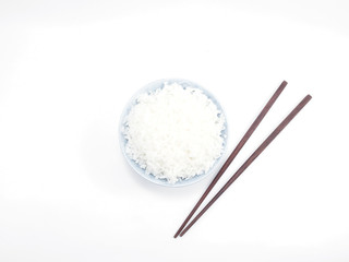 Rice in a bowl with chopsticks isolated top view